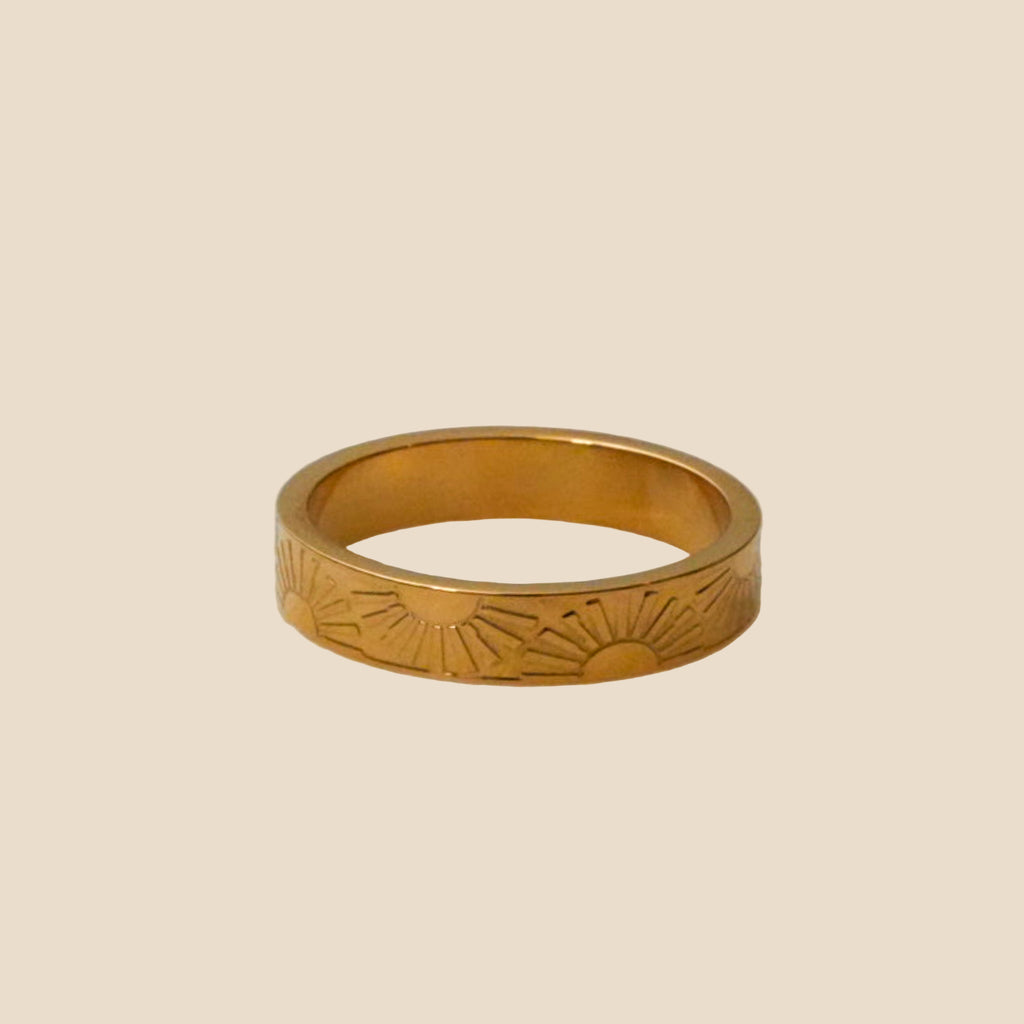 Stainless steel ring with a radiant sunburst design in 18K gold plating.